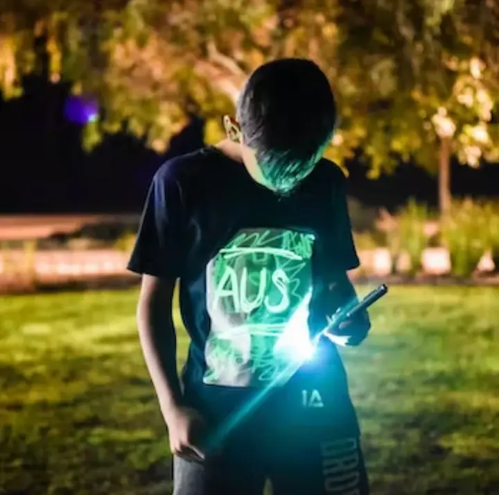 Older boy wears interactive glow t shirt